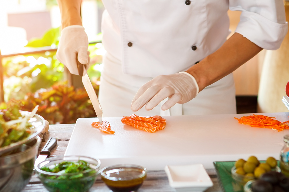 chef cutting fish meat 