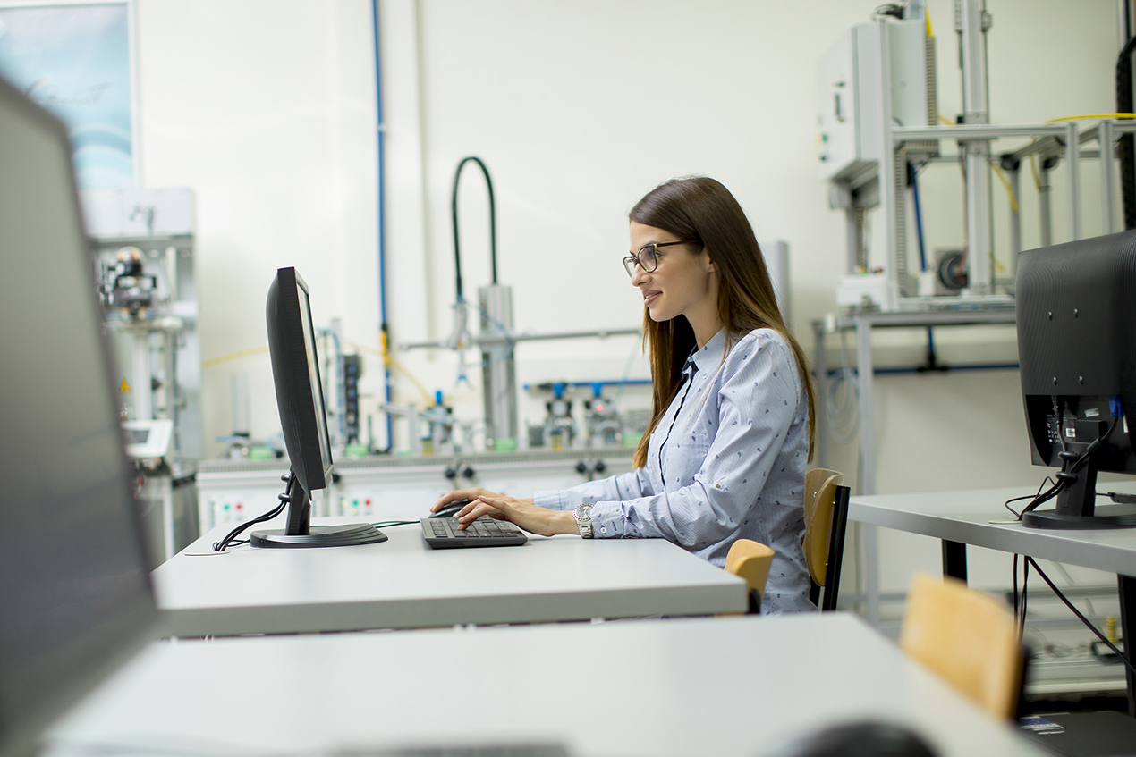 women sitting at a computer in a lab