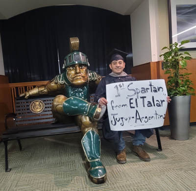 torres with sign and sparty statue